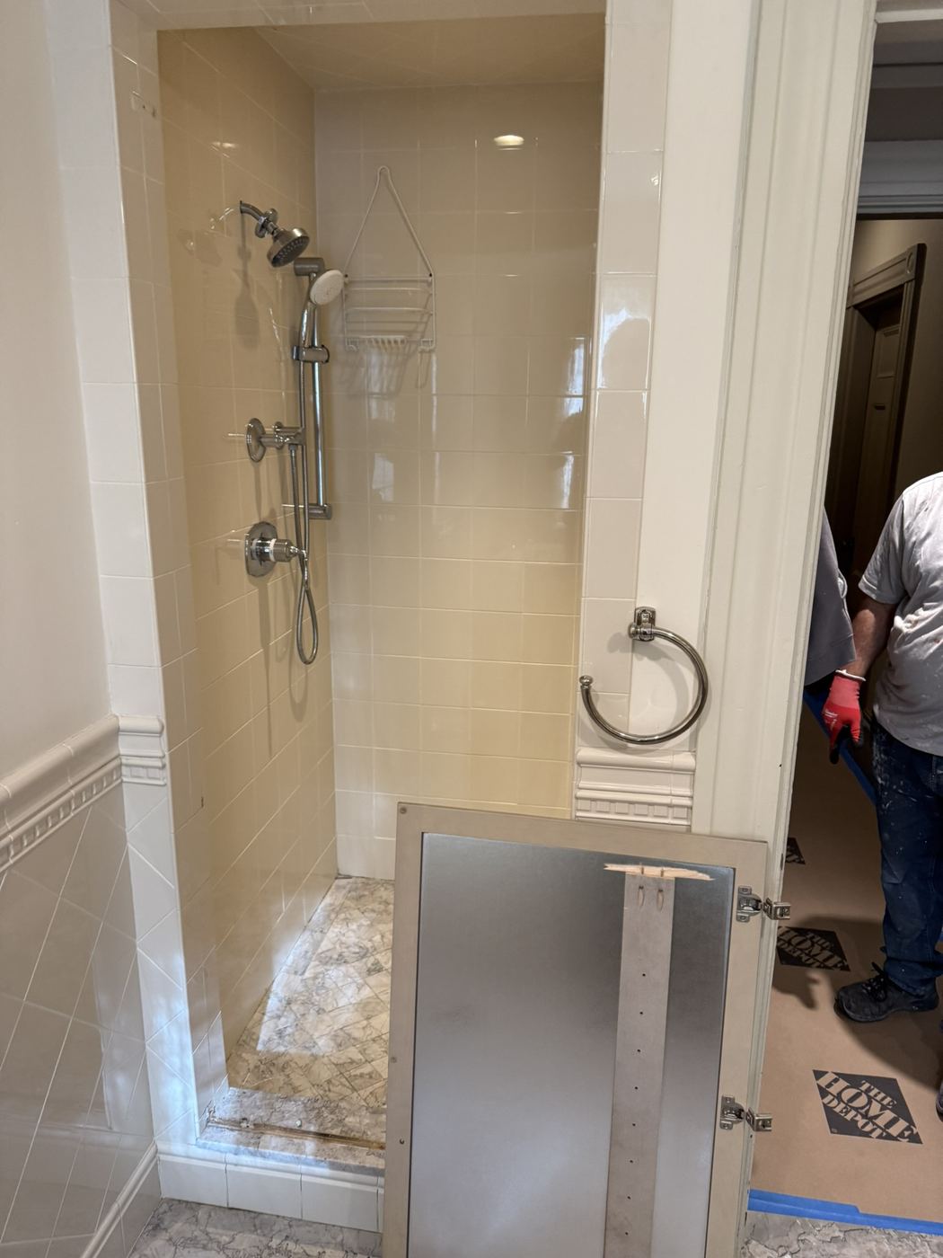 Old beige tiled shower stall before remodel
