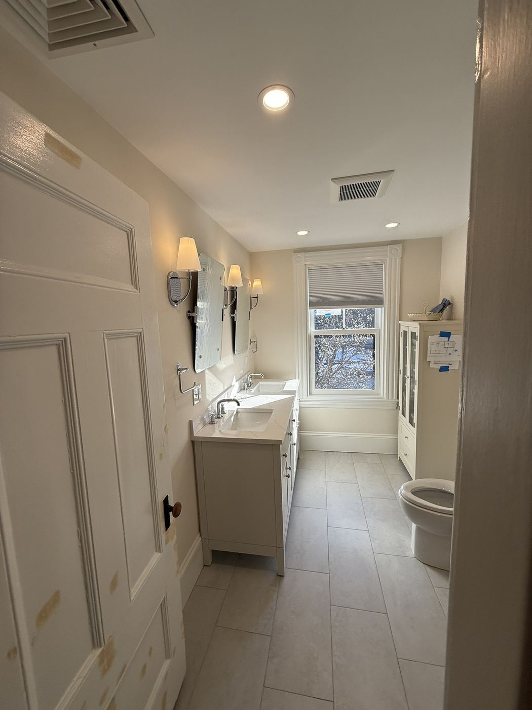 Remodeled bathroom with new vanity and tile floor